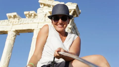 Young girl posing on background old ruins showing thumbs-up gesture Stock-Footage 131331505