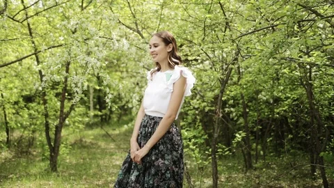 Young girl posing, dancing and fooling around in front of blooming garden Stock Footage 108829268