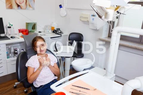 A young girl posing on dentist chair in a dentistry surgery Stock Photos