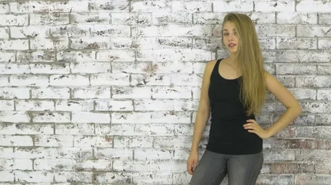 Young Girl Posing Near White Wall Stock Footage 59756604