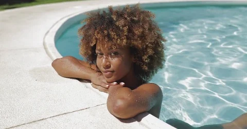 Young girl posing in water of pool Stock Footage