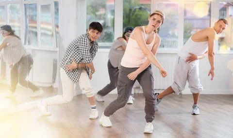 Young girl practicing basic hip hop steps in training hall 写真素材