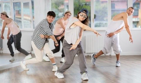 Young girl practicing basic hip hop steps in training hall 写真素材