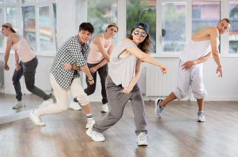 Young girl practicing basic hip hop steps in training hall 写真素材