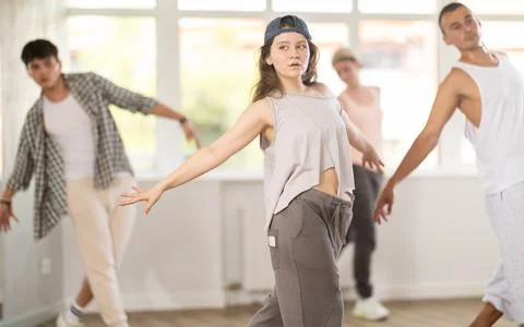 Young girl practicing basic hip hop steps in training hall 写真素材