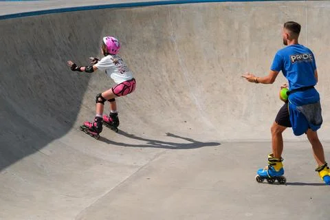 Young Girl Practicing Inline Skating Under Coach Supervision Stock Photos