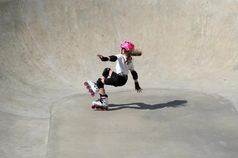 Young Girl Practicing Inline Skating in Concrete Skatepark Stock Photos