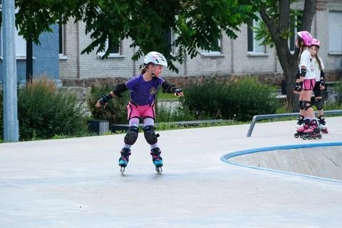 Young Girl Practicing Inline Skating at Outdoor Skatepark Stock Photos