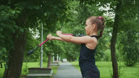 A Young Girl Practicing Precision and Coordination with Sports Equipment in a Stock Footage 314223318