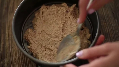 Young girl preparing first layer of raw vegan ice cream cake Stock Footage 74660880