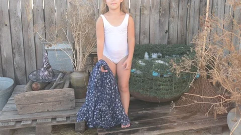 Young girl is preparing to take part in celebration of Halloween. Child is ba Stock Footage 93851853