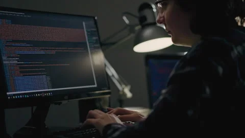 A young girl programmer in the IT sphere writes code while in her home offic Stock Footage 246311589