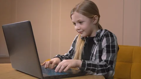 Young girl programming and typing on laptop indoors Stock Footage 315877698