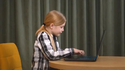 Young girl programming and typing on laptop indoors Stock-Footage 315877913