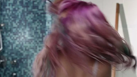 Young girl in puberty using a brush as a microphone in a bathroom with a lot  Stock Footage 76780771