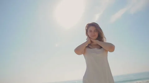 The young girl pulls hands to the sun and smiles Stock Footage 62548372