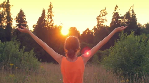 Young girl raising her hands and feeling free, spirituality, sunrise Stock Footage