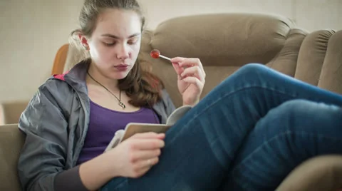 The Young Girl Is Reading A Book On The Tablet Stock Footage 36451663