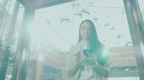 Young girl riding in an elevator and looking phone Stock Footage 59082917