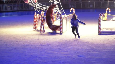 Young girl rolling on the ice skating rink Stock Footage 149079334