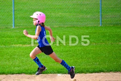 Young Girl Running Bases in Softball Stock Photos