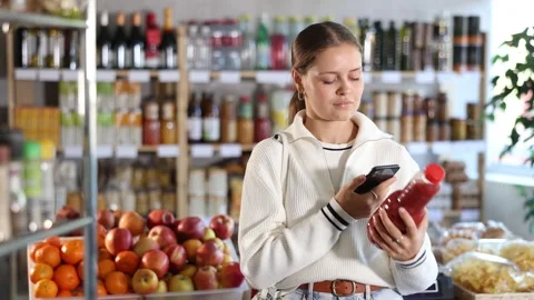 Young girl scanning qr code for tomato juice Video stock 329541401