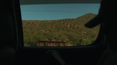 Young girl scrolls through screen of her phone while sitting in car and drives Vidéo 302168264