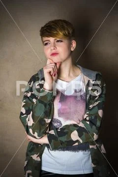 Young girl with short haircut concrete wall on background Stock Photos