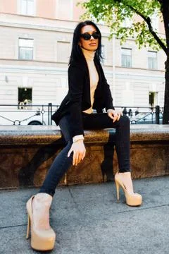 Young girl sits on the street Stock Photos