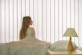 The young girl sitting on the bed Photo