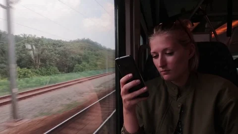 Young girl sitting in the train window Vídeo Stock 116125370