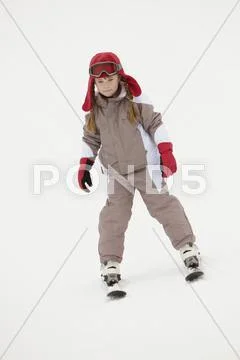 Young Girl Skiing Down Slope On Holiday In Mountains Stock Photos