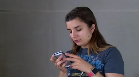 Young girl in smart watch using smartphone, texting, playing games Stock Footage 68370665