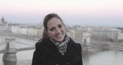 Young girl smiling into camera with panoramic view Budapest 4K Stock Footage 46916403