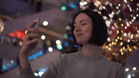 Young girl smiling laughing using smartphone taking selfie in shopping mall Stock Footage 83367807