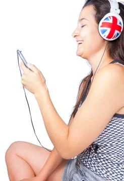 Young girl smiling with phone and headphones Stock Photos