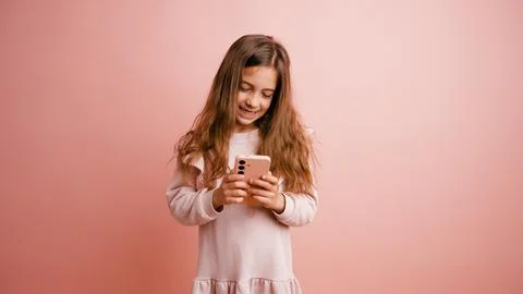 Young girl smiling while using smartphone apps Stock Photos