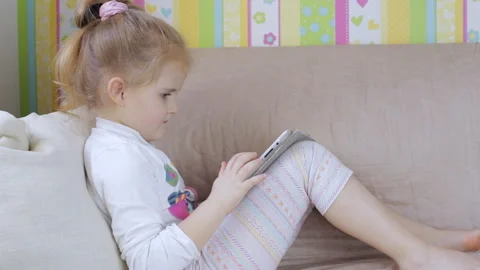 Young girl on sofa with tablet computer at home Stock-Footage 87249176