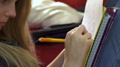 Young girl solves math problems sitting on couch 4k Stock Footage 58773630