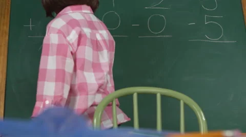 Young girl solving math problems on chalkboard Stock Footage 67356426