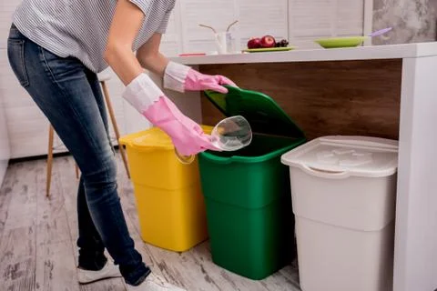 Young girl sorting garbage at the kitchen. Concept of recycling. Zero waste Stock Photos