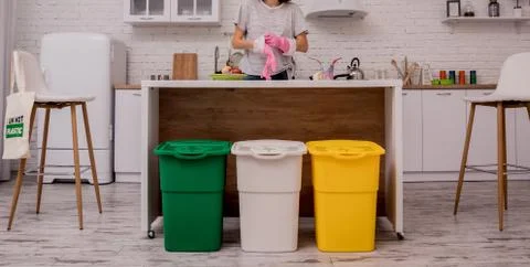 Young girl sorting garbage at the kitchen. Concept of recycling. Zero waste Stock Photos