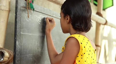 Young girl student in Bengal, India, writes in Bengali on a chalkboard Stock Footage