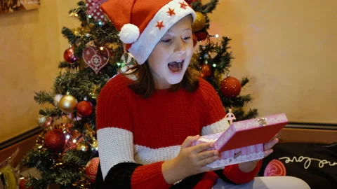 Young girl is surprised while opening the carillon in Christmas 動画素材 141044152