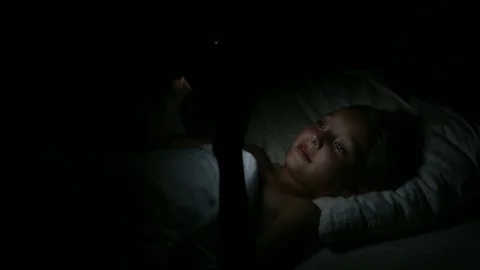 Young girl with tablet computer lying on bed. Cute Little Girl in Her Room at Vidéo 79383763