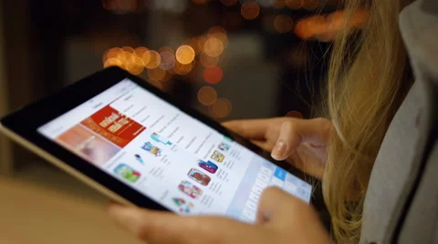 Young girl on a Tablet PC application chooses for himself and is going Stock Footage 59961976
