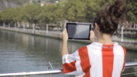 Young girl with tablet at river Stock Footage