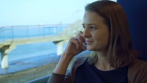 Young girl talking on cell phone on the train Stock Footage