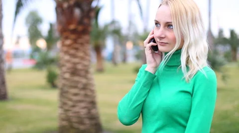 Young girl talking on mobile cell phone smiling, outdoors.  Happy Woman Stock Footage 60114820
