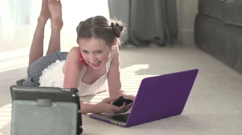 A young girl talks, surrounded by technology. Stock Footage 44114323